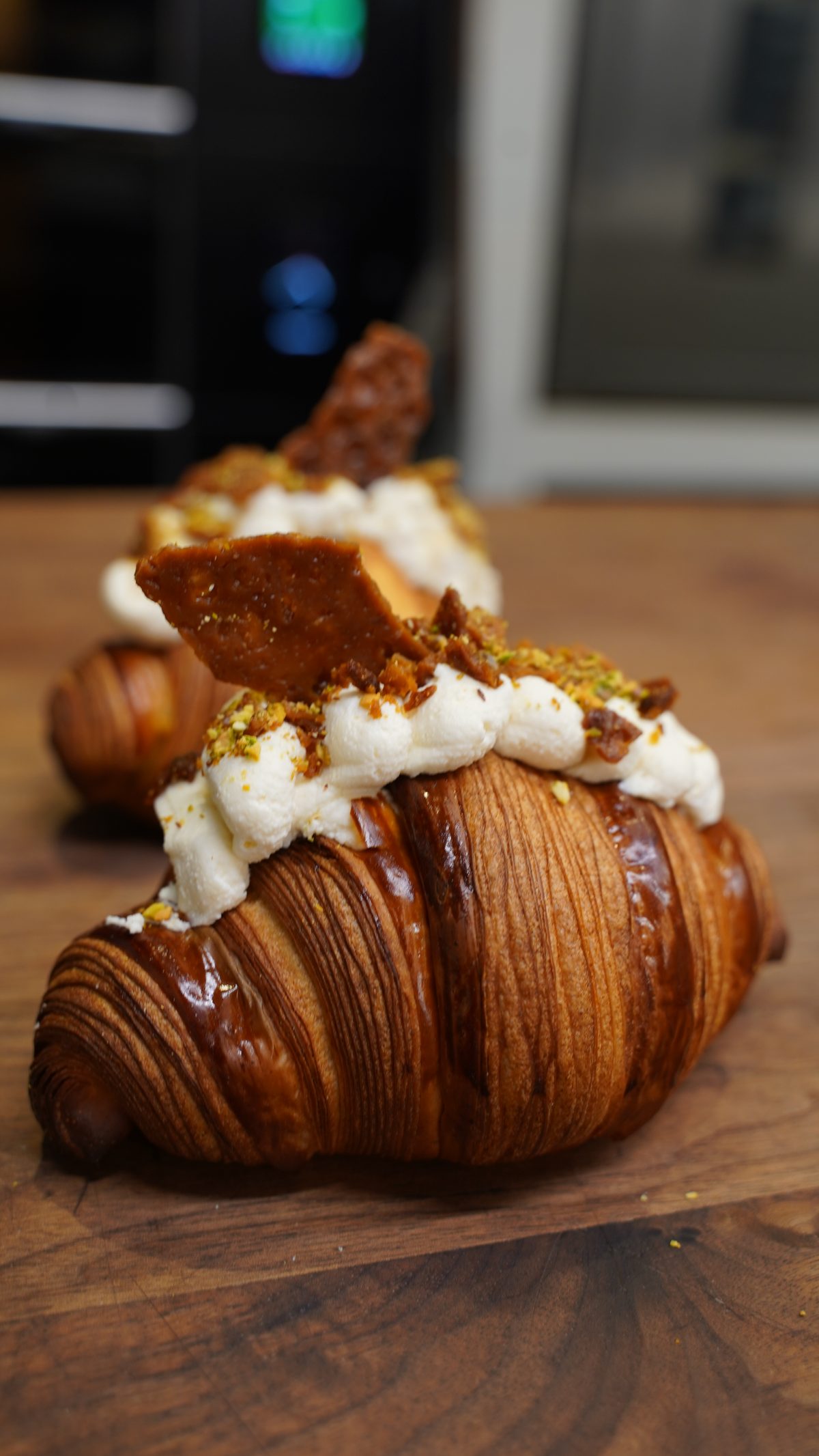 Croissant topped with chantilly and pistachio